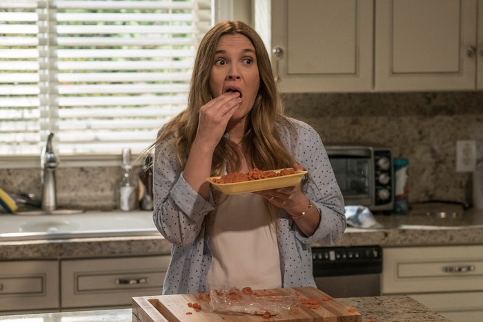 Drew Barrymore eating food in a kitchen