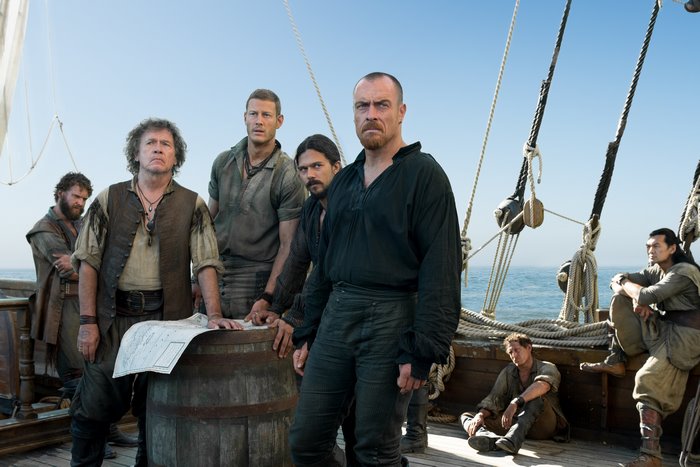 Toby Stephens and crew on a ship deck