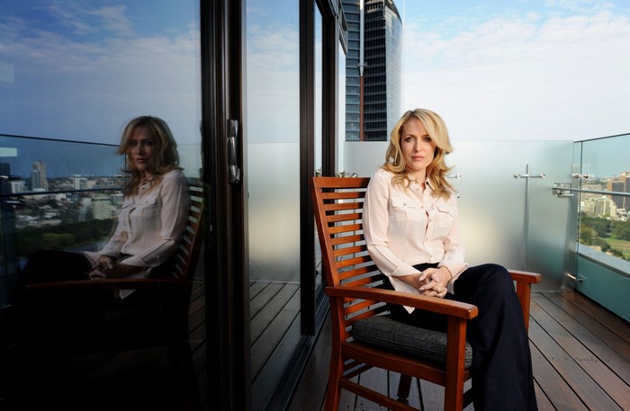Gillian Anderson sitting on a balcony