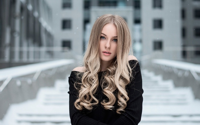 Woman with blonde hair in black top outdoors in winter