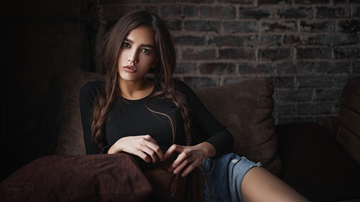 Woman with braided hair sitting on a couch