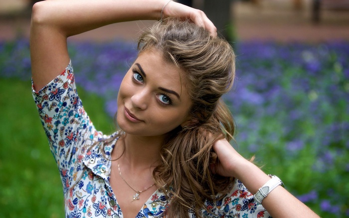 Woman with blue eyes and floral shirt