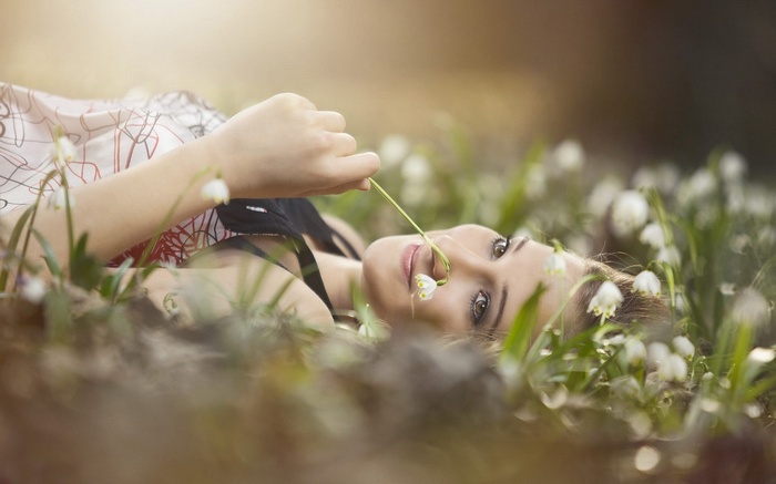 Woman lying in a field of flowers