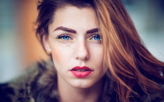 Woman with blue eyes and red lipstick