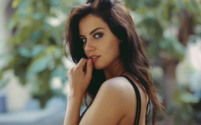 Woman with dark hair and blue eyes
