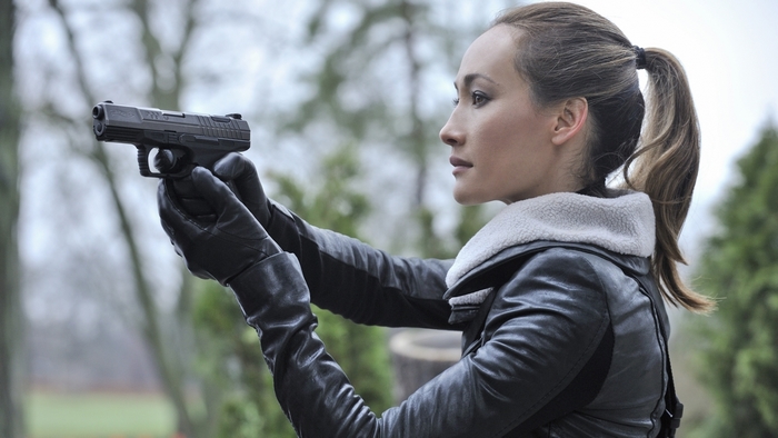 Maggie Q holding a handgun