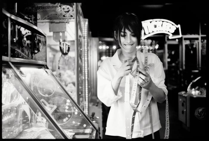 Winona Ryder holding tickets in an arcade