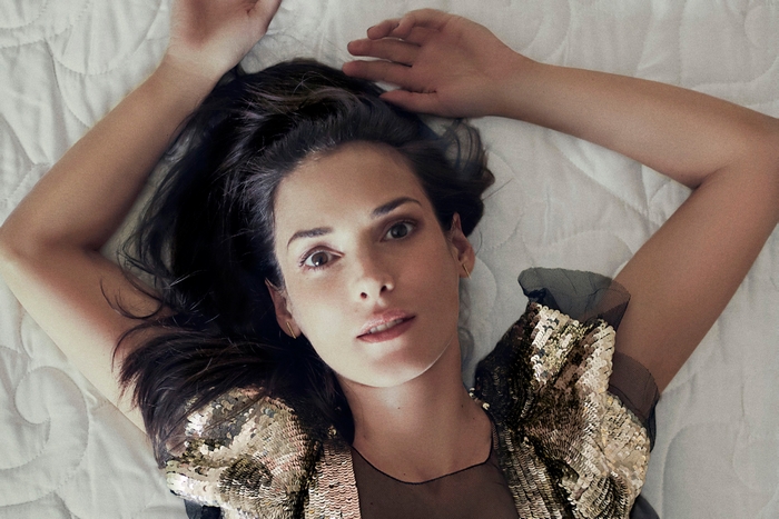 Winona Ryder lying on a bed