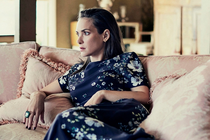Winona Ryder sitting on a couch