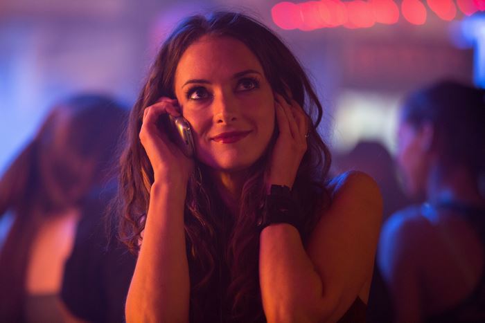 Winona Ryder on a phone in a club