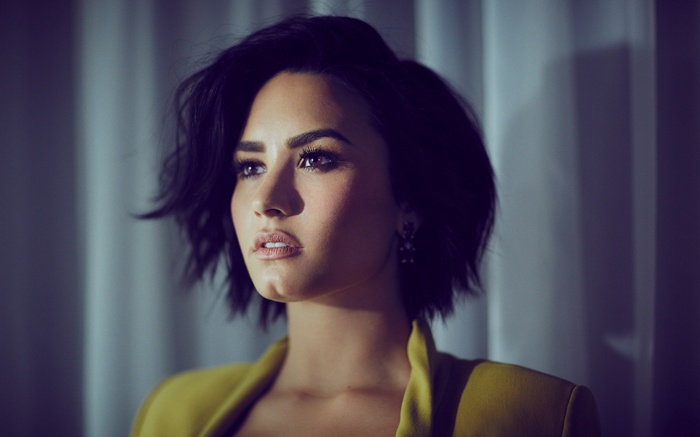 Demi Lovato in a yellow jacket