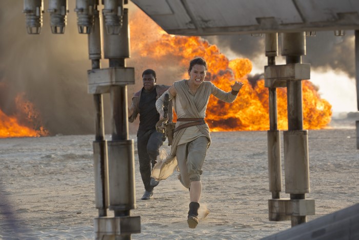 Rey and Finn running from explosion in Star Wars