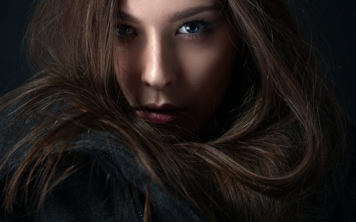 Woman with long brown hair and blue eyes