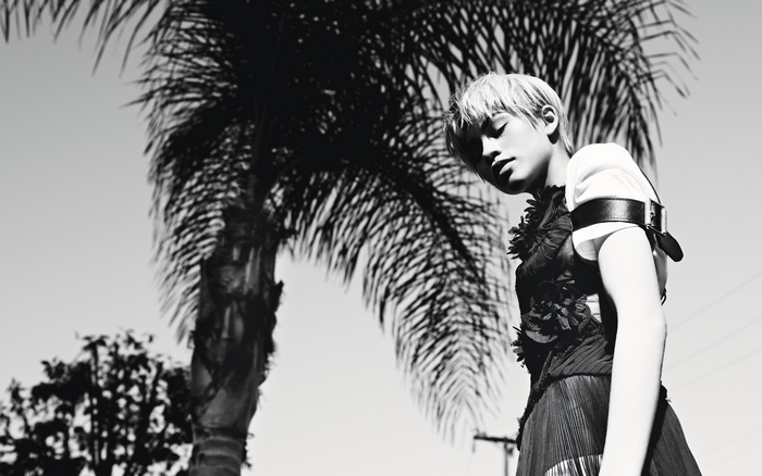 Zendaya posing in front of palm trees