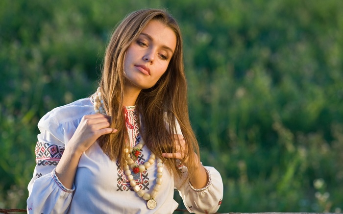 Woman in traditional Ukrainian clothing with beaded necklace