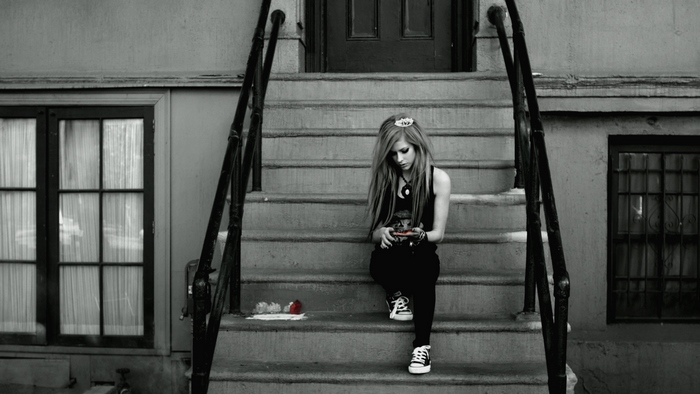 Avril Lavigne sitting on stairs