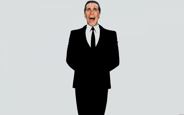 Christian Bale in a suit with blood