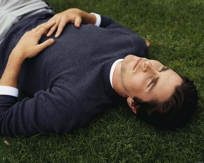 Christian Bale lying on grass