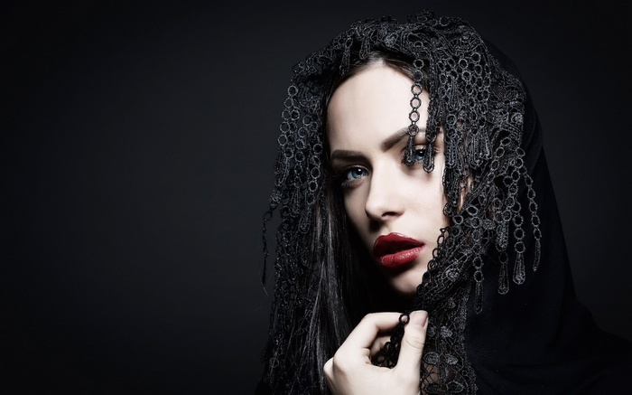 Woman in black veil with red lipstick