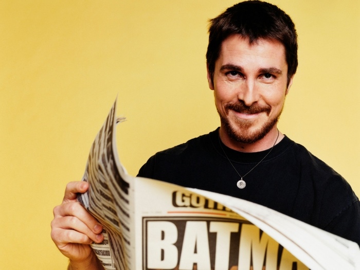 Christian Bale reading a newspaper