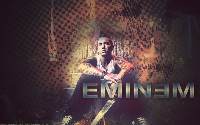 Eminem sitting in front of a textured wall