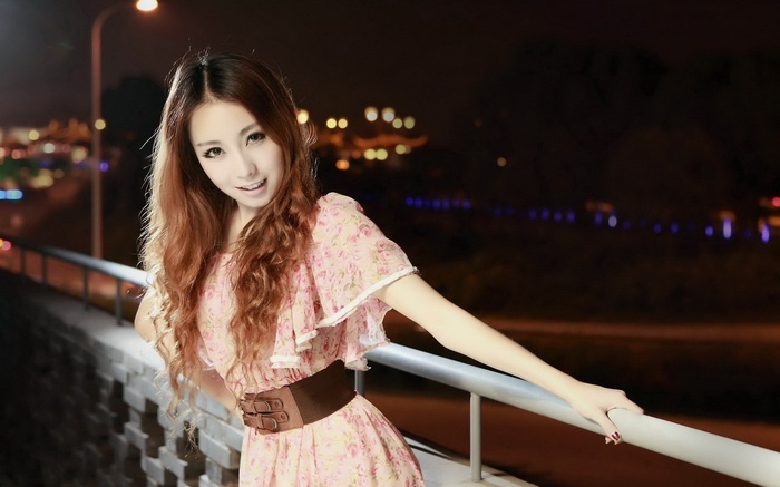 Woman in floral dress at night