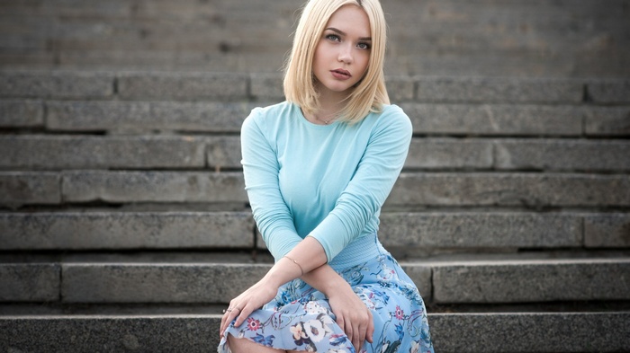 Woman sitting on stone steps