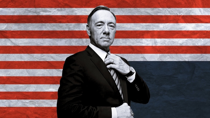 Kevin Spacey in front of American flag
