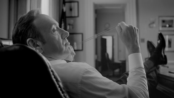 Kevin Spacey playing with a rubber band