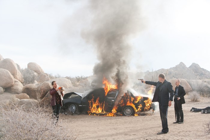 Sam Rockwell with dog by burning car