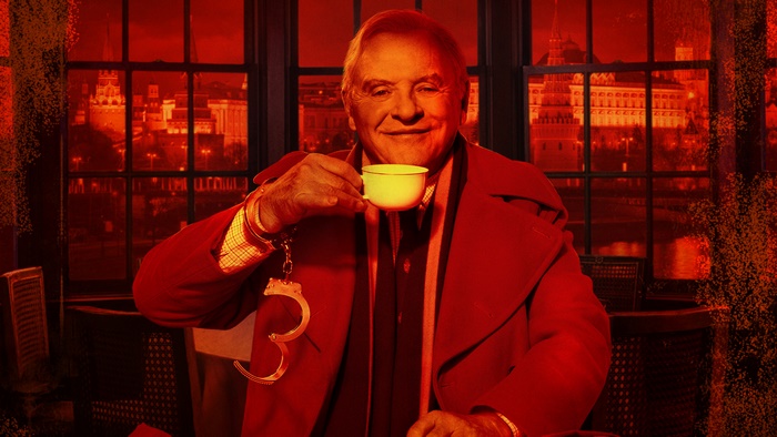 Anthony Hopkins holding a teacup with handcuffs