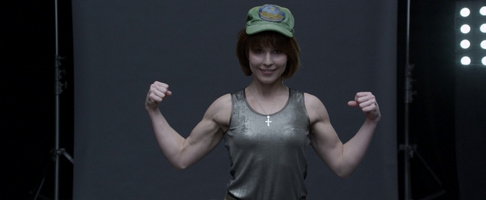 Noomi Rapace flexing in a studio