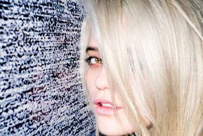 Sky Ferreira against static background