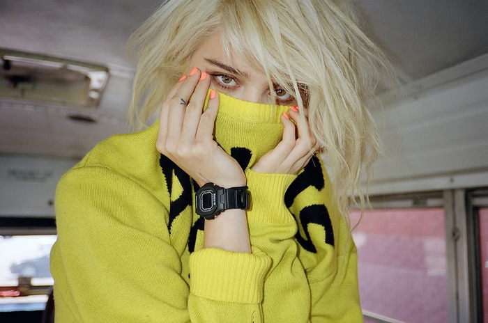 Sky Ferreira wearing a yellow sweater