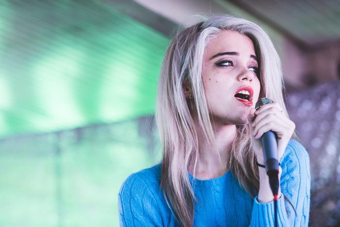 Sky Ferreira singing into a microphone