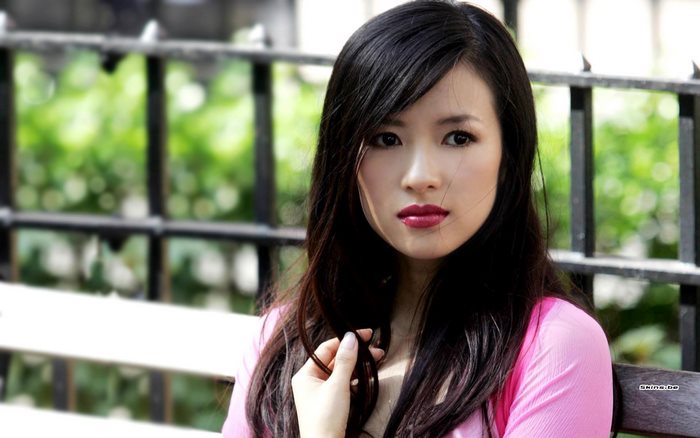 Zhang Ziyi sitting on a bench