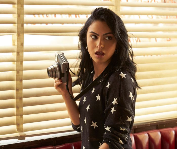 Camila Mendes holding a camera