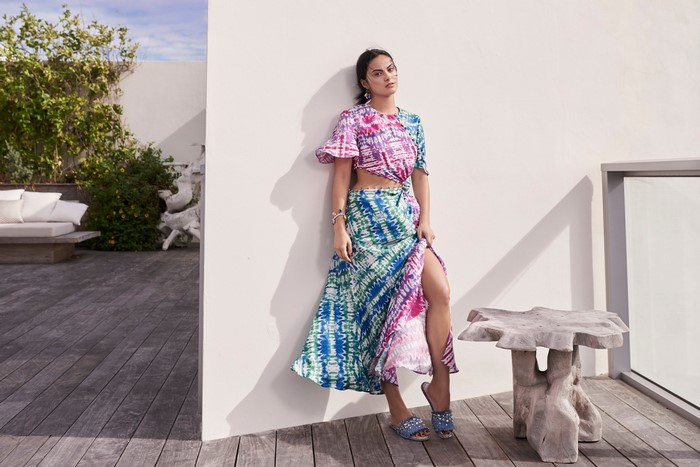 Camila Mendes in a tie-dye outfit on a patio
