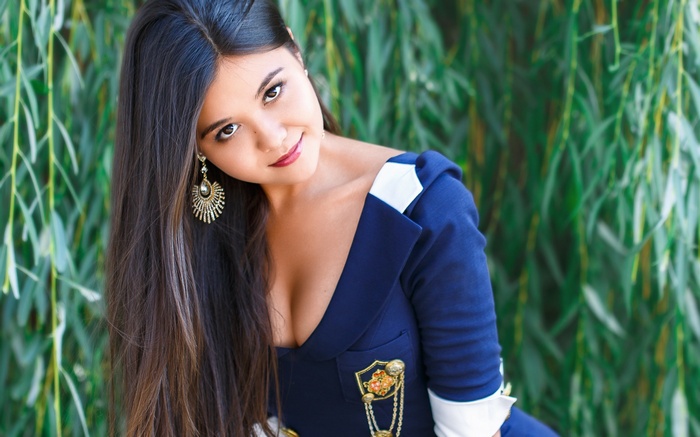 Woman in a blue dress with gold earrings