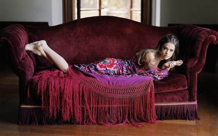 Denise Richards on a velvet couch