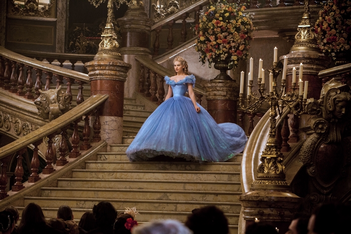 Lily James as Cinderella on a grand staircase