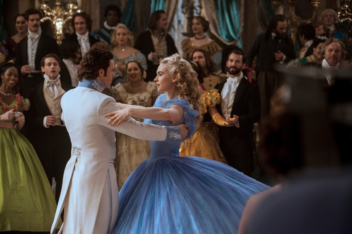 Lily James and Richard Madden dancing at a ball