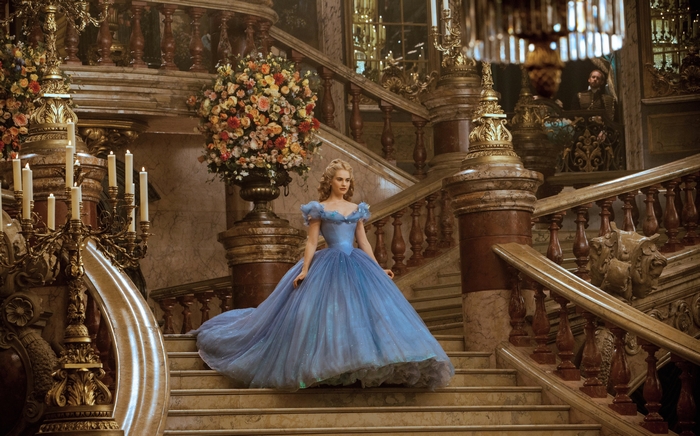 Lily James as Cinderella on a grand staircase