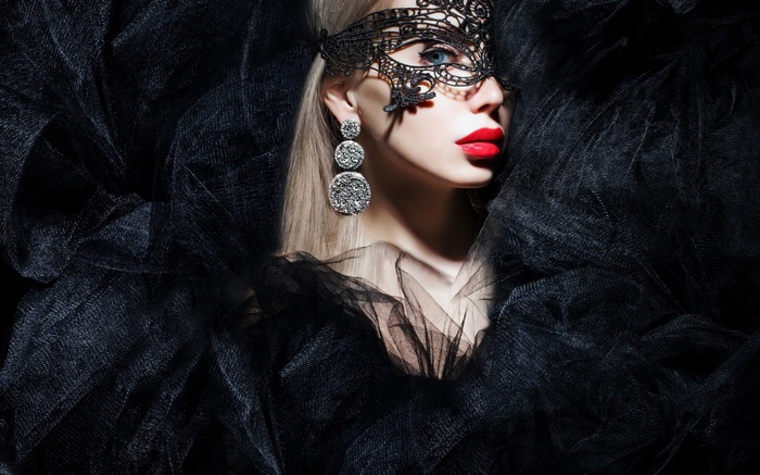 Woman in black lace mask and earrings