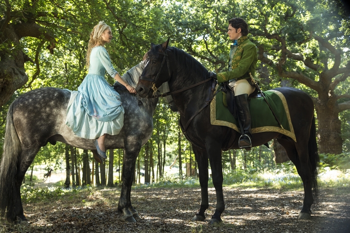 Lily James on horseback in a forest