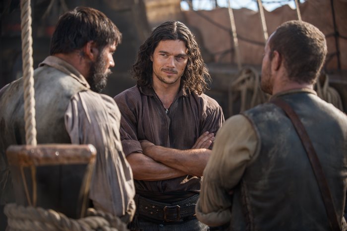 Luke Arnold and two men on a ship