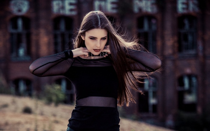 Woman in black top with choker necklace