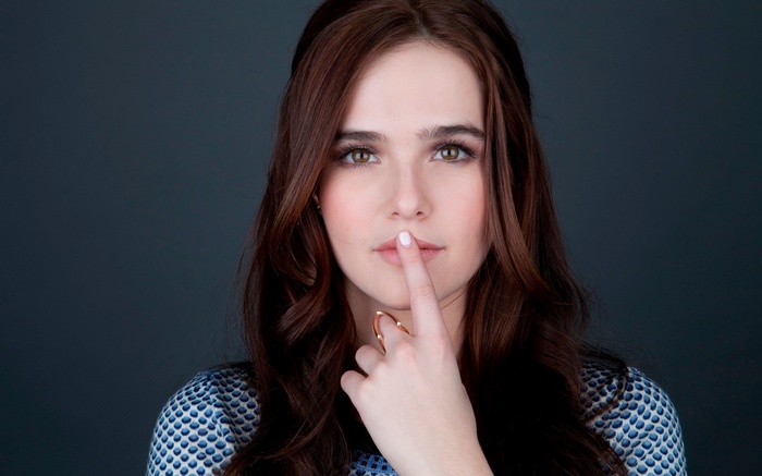 Zoey Deutch with finger on lips
