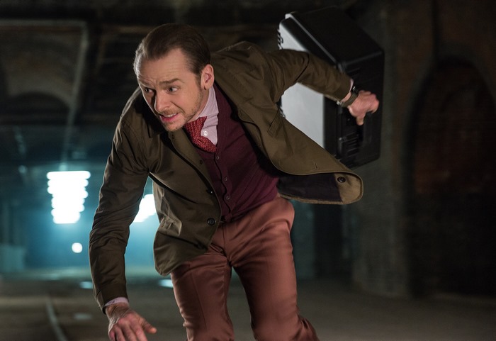 Simon Pegg carrying a black case