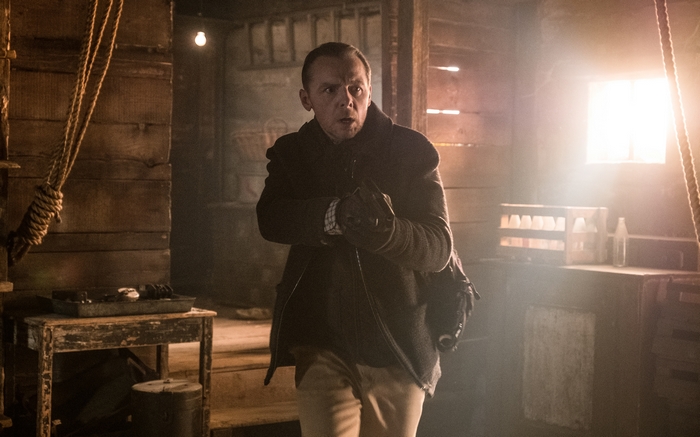 Simon Pegg in a dimly lit wooden structure